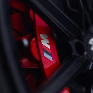 Close-up of BMW M performance brake caliper and drilled brake disc